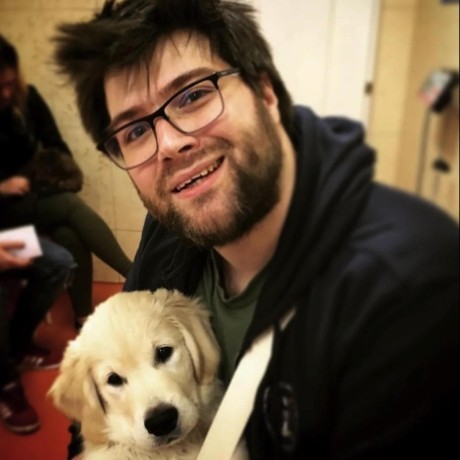Chris von Csefalvay holding his golden retriever puppy.